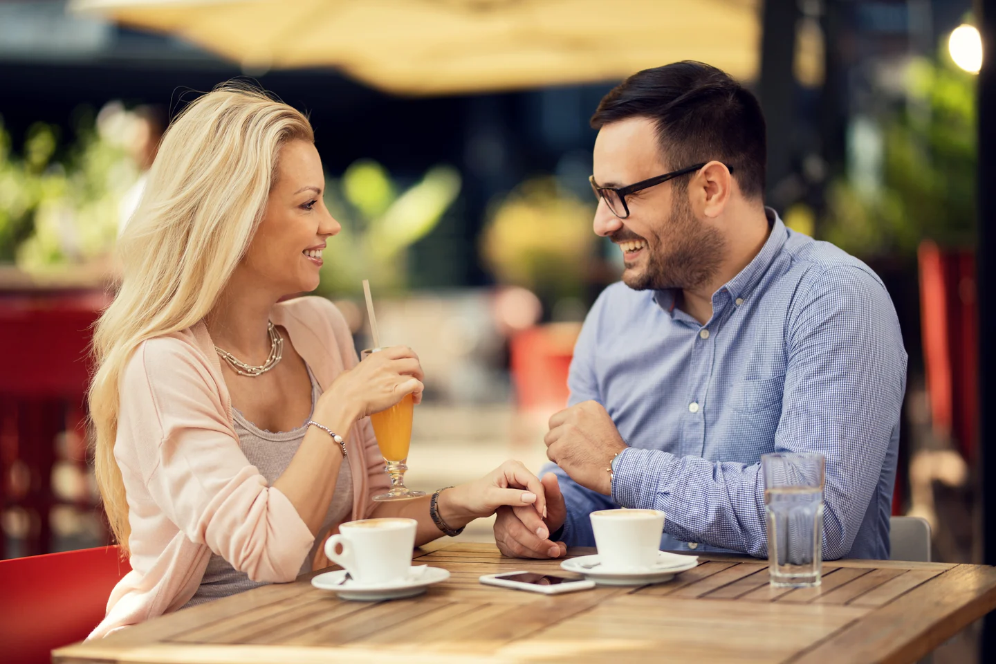 Couple smiling and talking during a relaxed café date